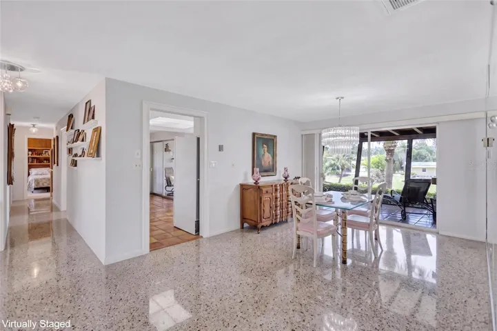 Virtually Staged Dining Room showing Terrazzo Flooring beneath the carpet.