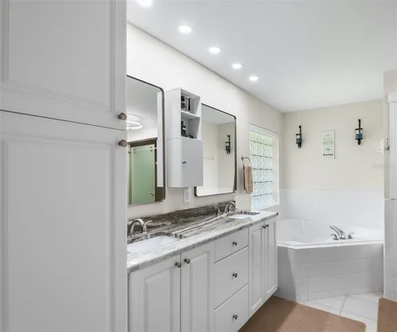 Ensuite bath with walk in closet, dual sinks, Garden Tub and just around the corner a beautifully remodeled walk in shower with sliding glass doors.