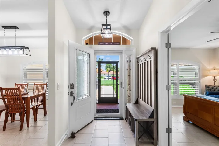 Front windows are accented with custom plantation shutters, adding timeless elegance and enhancing the home's curb appeal.