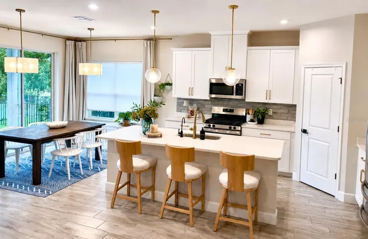 Open floor plan, wood-like tile, upgraded lighting, quartz countertops, solid wood cabinets