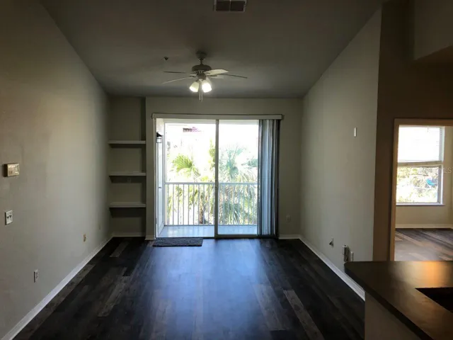 Living room with built-in shelving and Screened patio