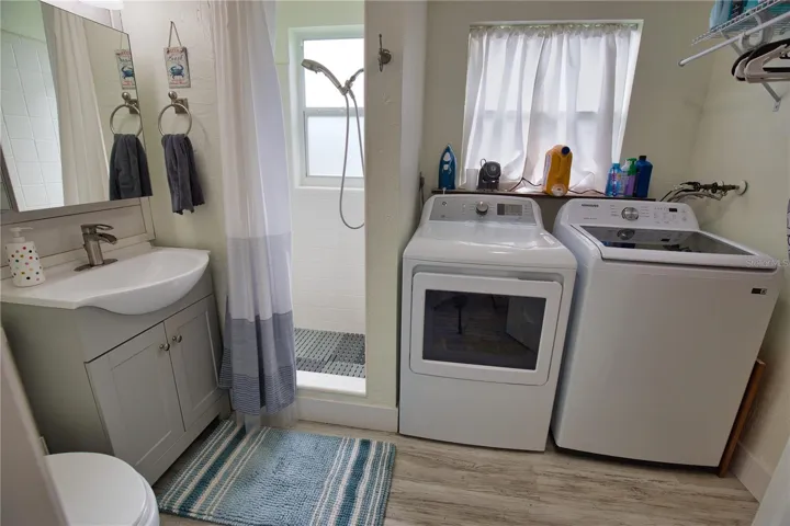Hall Bath with new vanity, sink and faucet.  Full size Washer Dryer.
