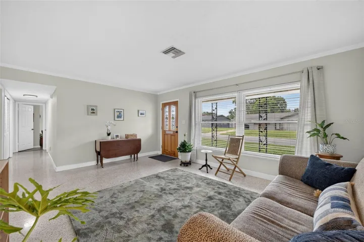 Living showcasing large windows to bring in lots of light to home