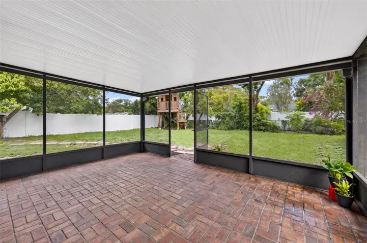 Screened in porch with brick paver flooring