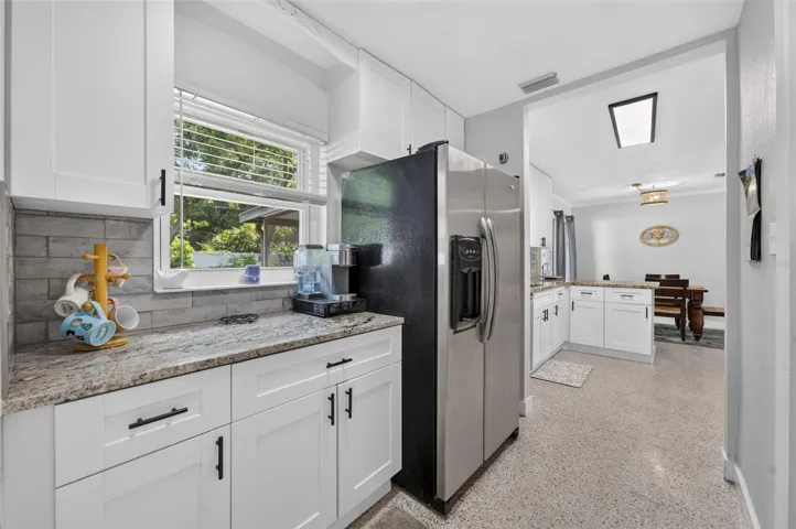 Kitchen coffee station space with additional cabinetry and counter space