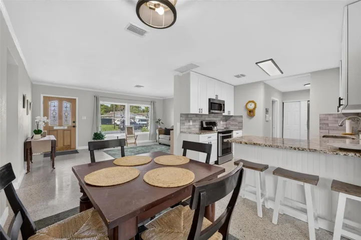 Dining open to kitchen and living spaces