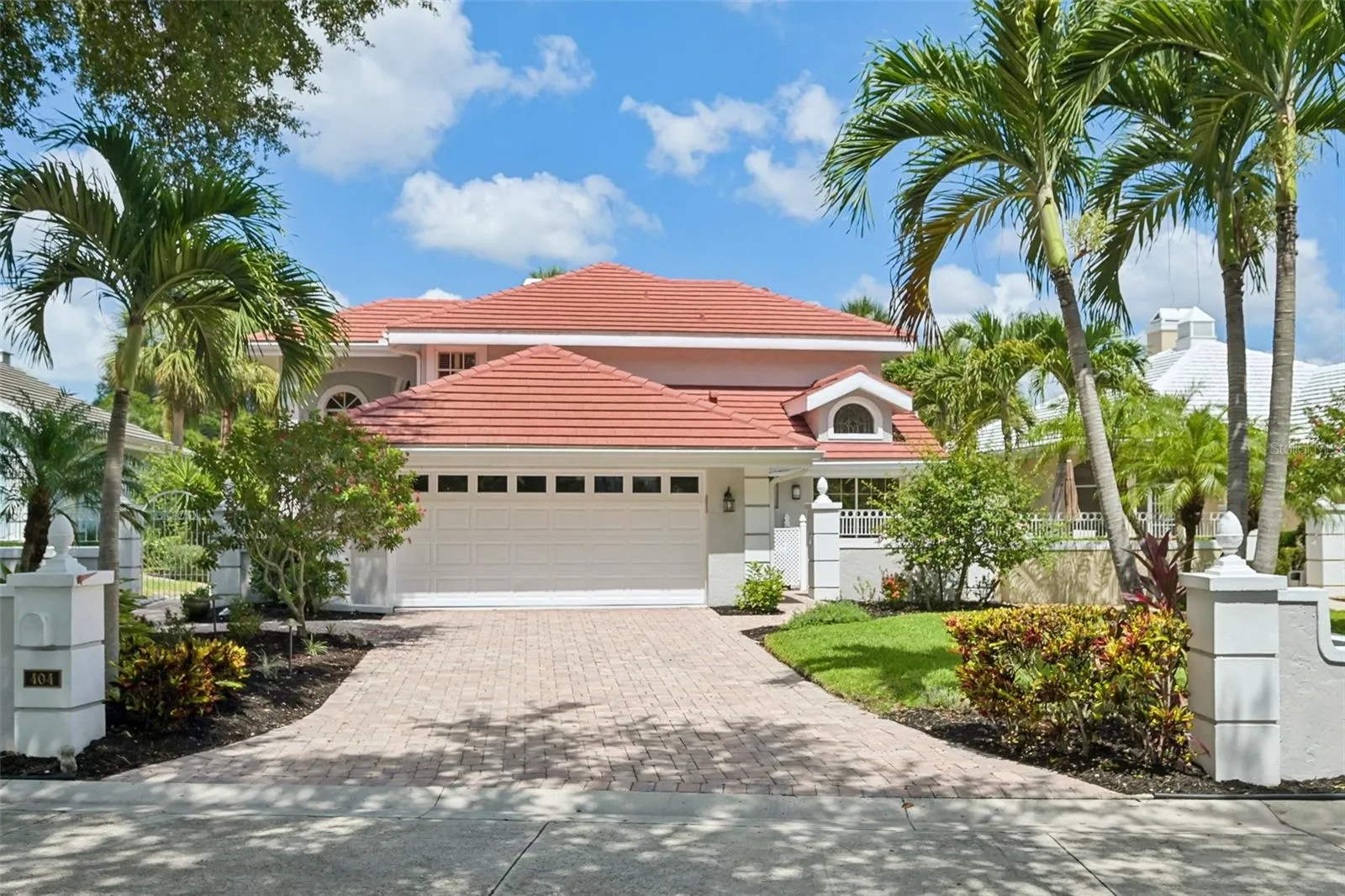 Double garage, paved drive, lush professional landscaping.
