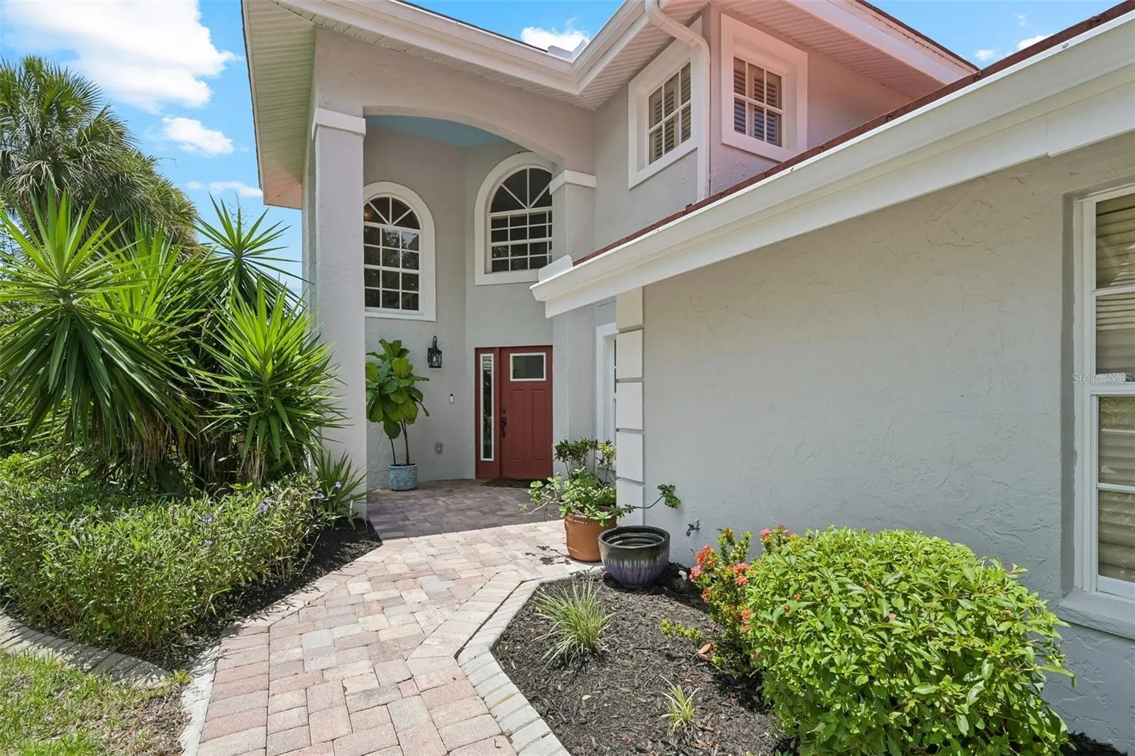 Winding paved path to the impressive front entrance.