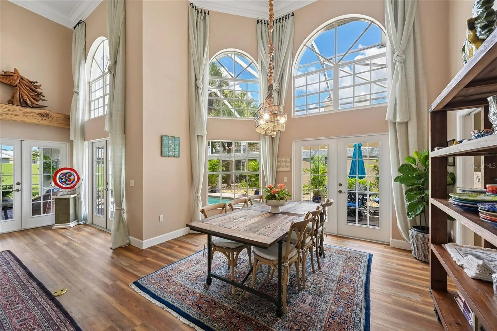 Wall to ceiling windows frame the formal dining area and overlook the gorgeous lanai area.