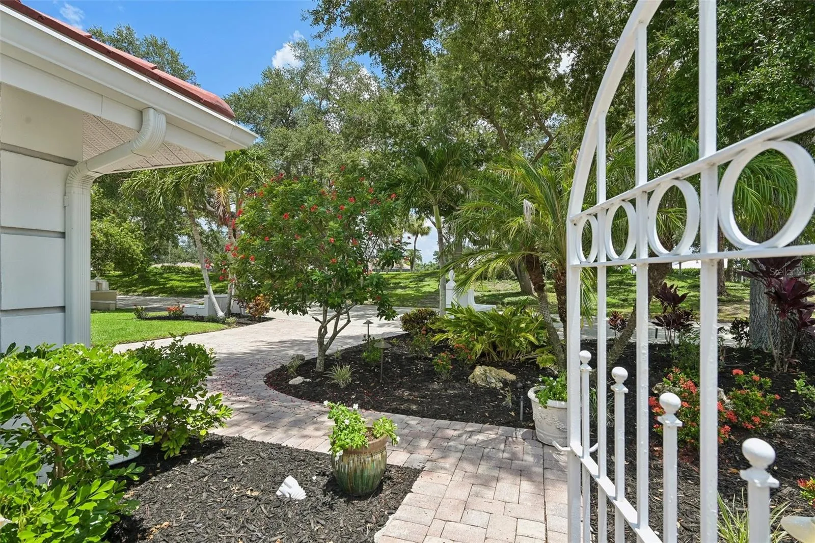 Lush tropical landscaping with irrigation and uplighting.