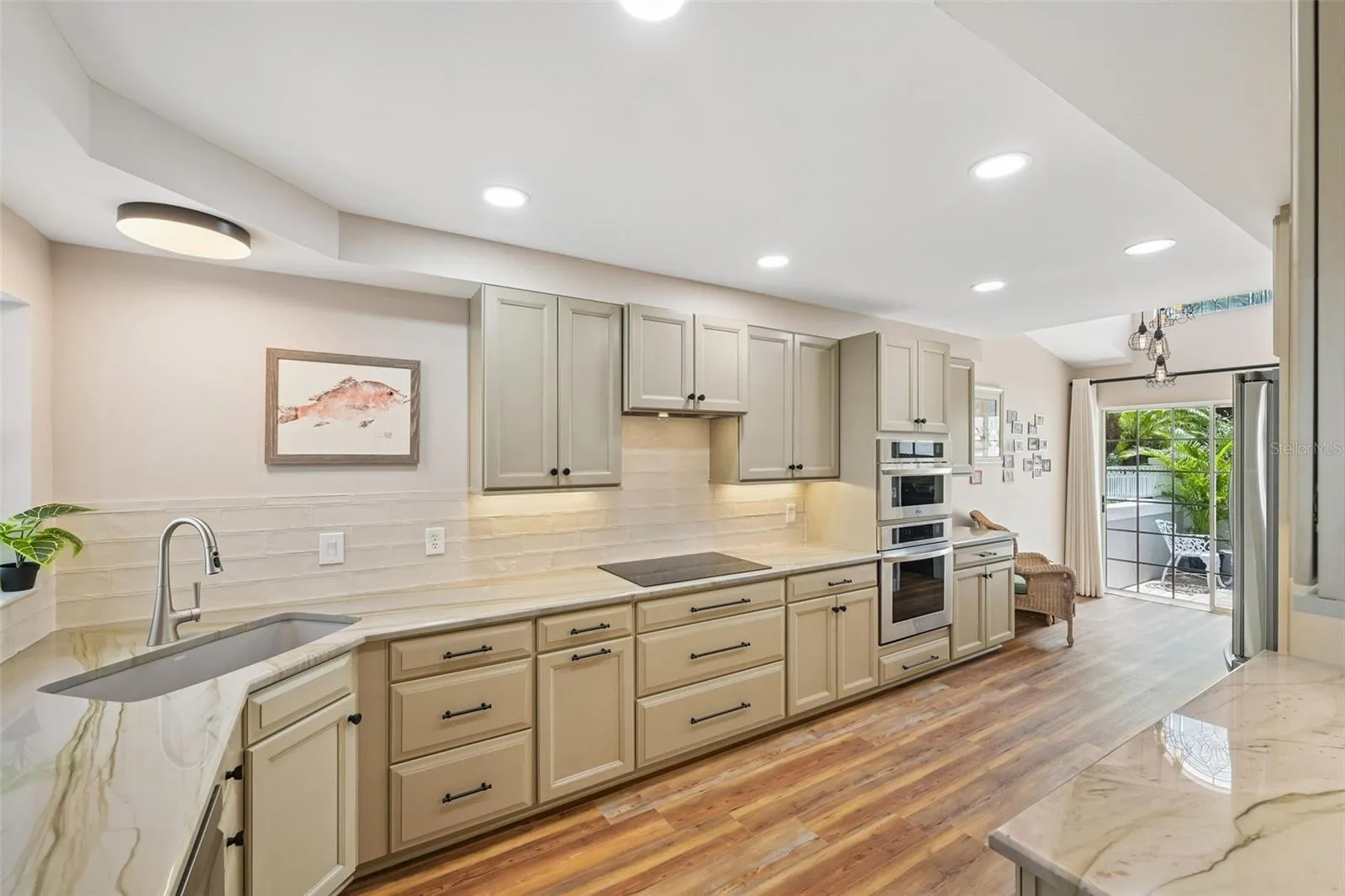 Gourmet kitchen with abundant custom cabinetry, farm sink, stainless steel appliances.
