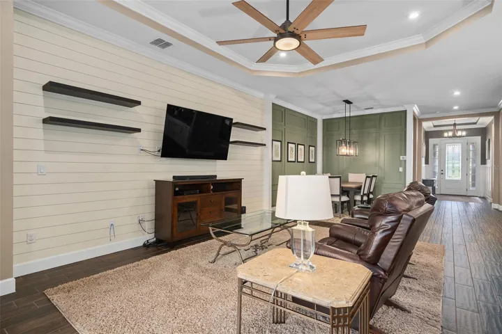 View of the Great Room, Dining Room and Foyer. Ceramic Wood Look tile graces the Main Living Area.