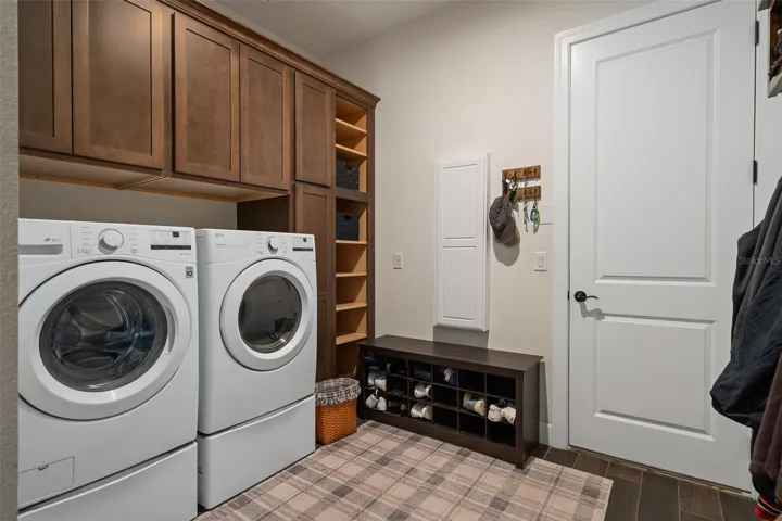 The Laundry Room offers the convenience of extra cabinetry for additional storage. There is an area to also hang jackets. The Washer and Dryer is included.