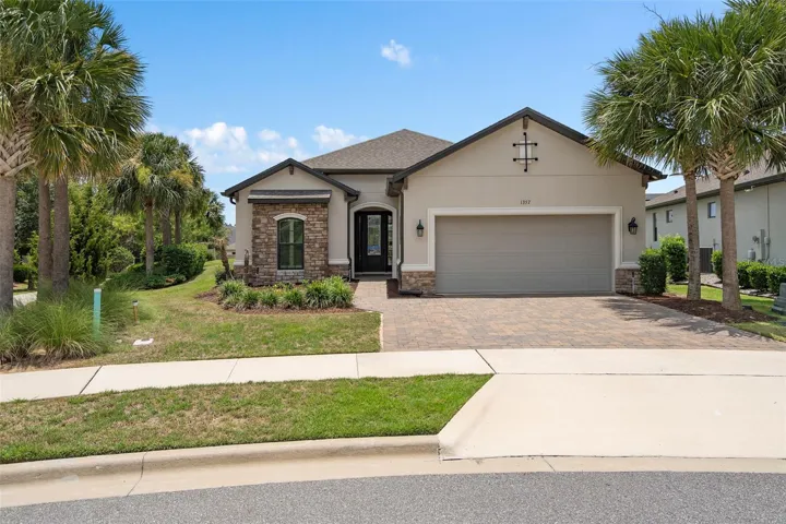 Front Elevation with a Tandem 3 Car Garage and Stone Accents. All this is situated on an Oversized Premium Lot.