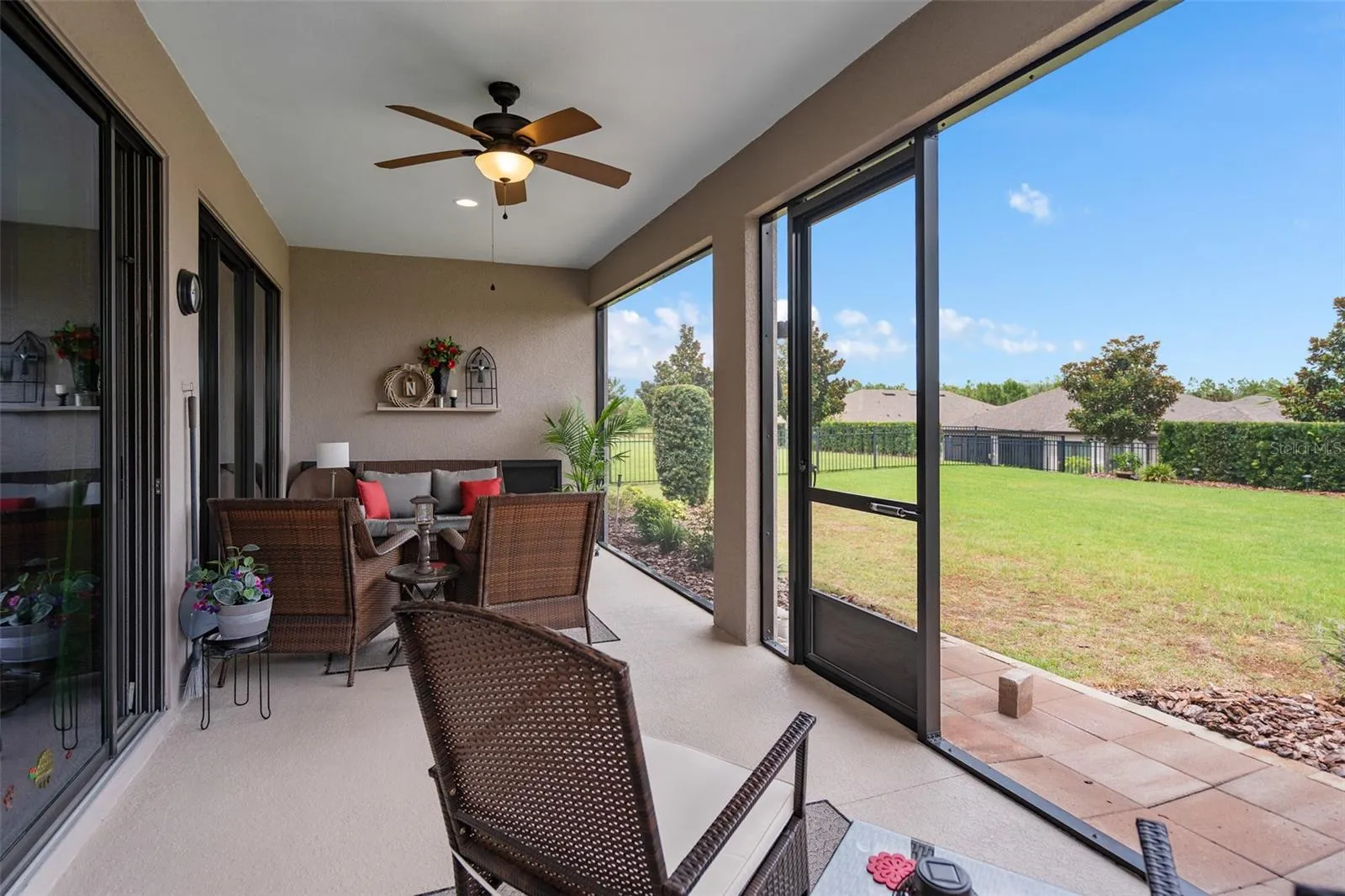 A Spacious Under Roof Lanai with Views of the Fenced Rear Yard