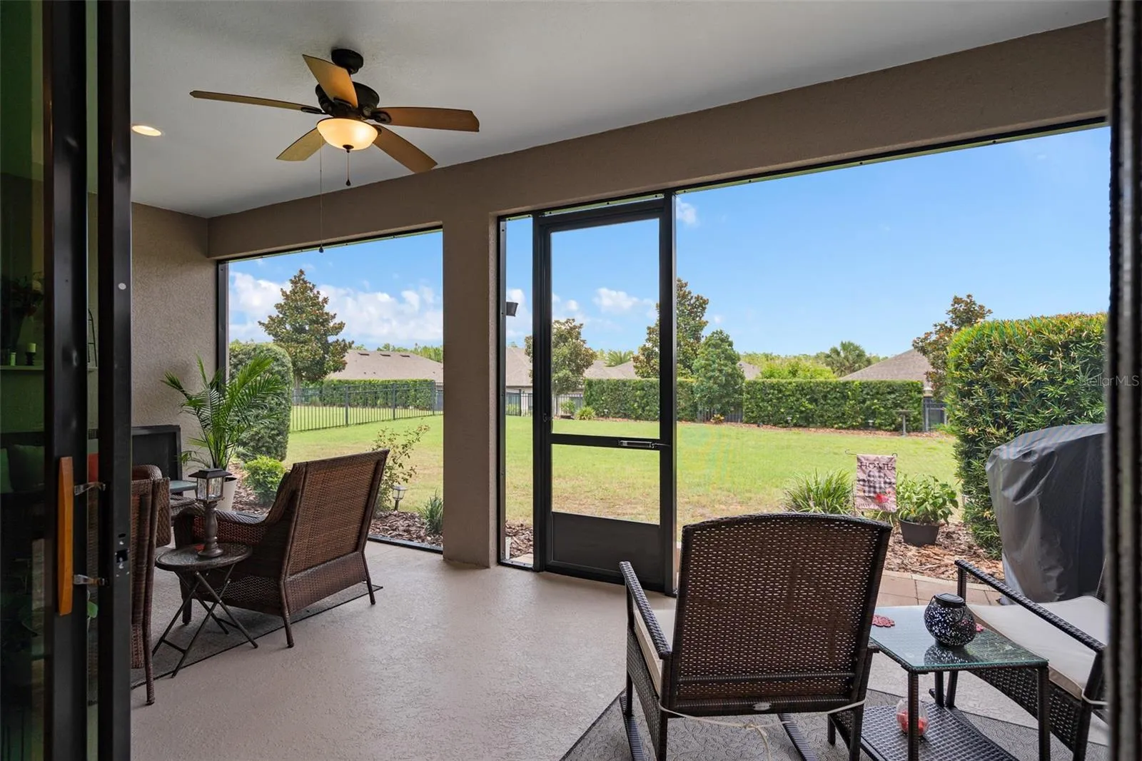 A Spacious Under Roof Lanai with Views of the Fenced Rear Yard