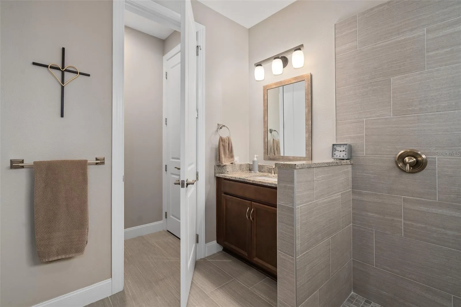 Primary En-Suite Water Closet with a Comfort Height Toilet and Linen Closet