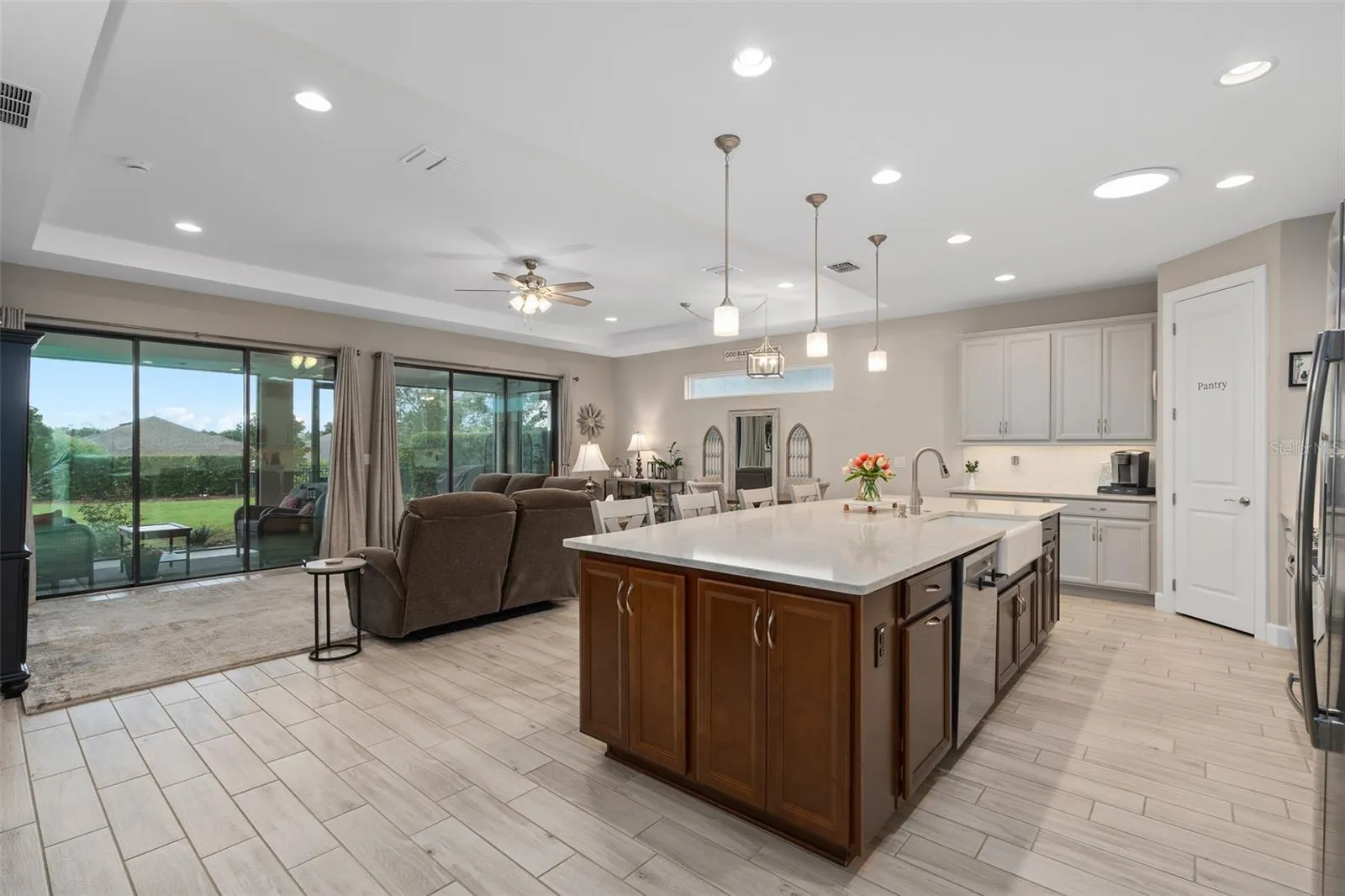 A View of the Kitchen, Great Room and Dining Area with a Great View of the Lanai and Rear Fenced Yard