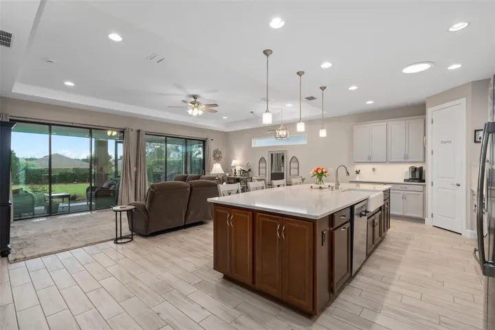 A View of the Kitchen, Great Room and Dining Area with a Great View of the Lanai and Rear Fenced Yard