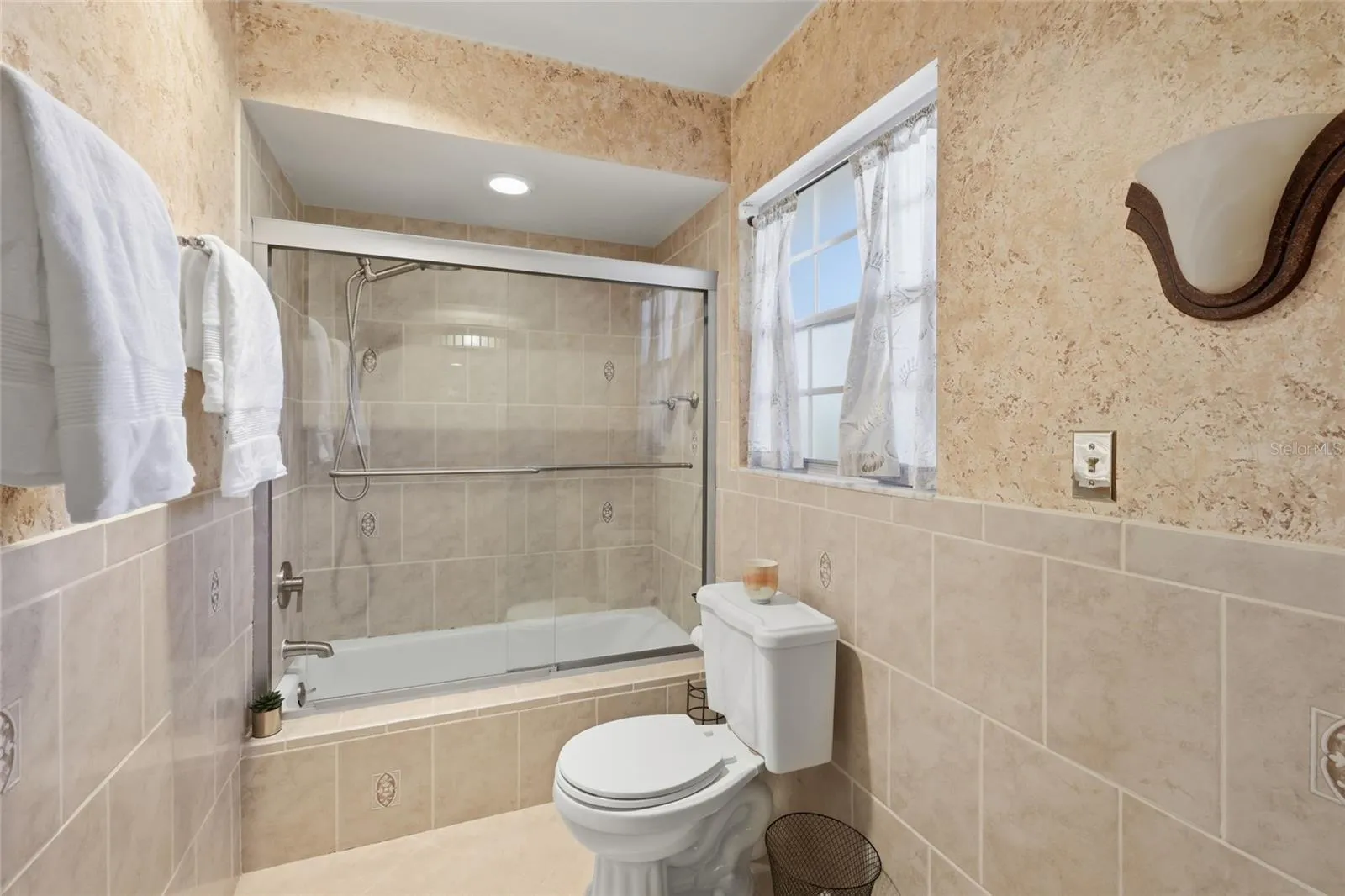 Primary bathroom gets natural sunlight with a privacy window.