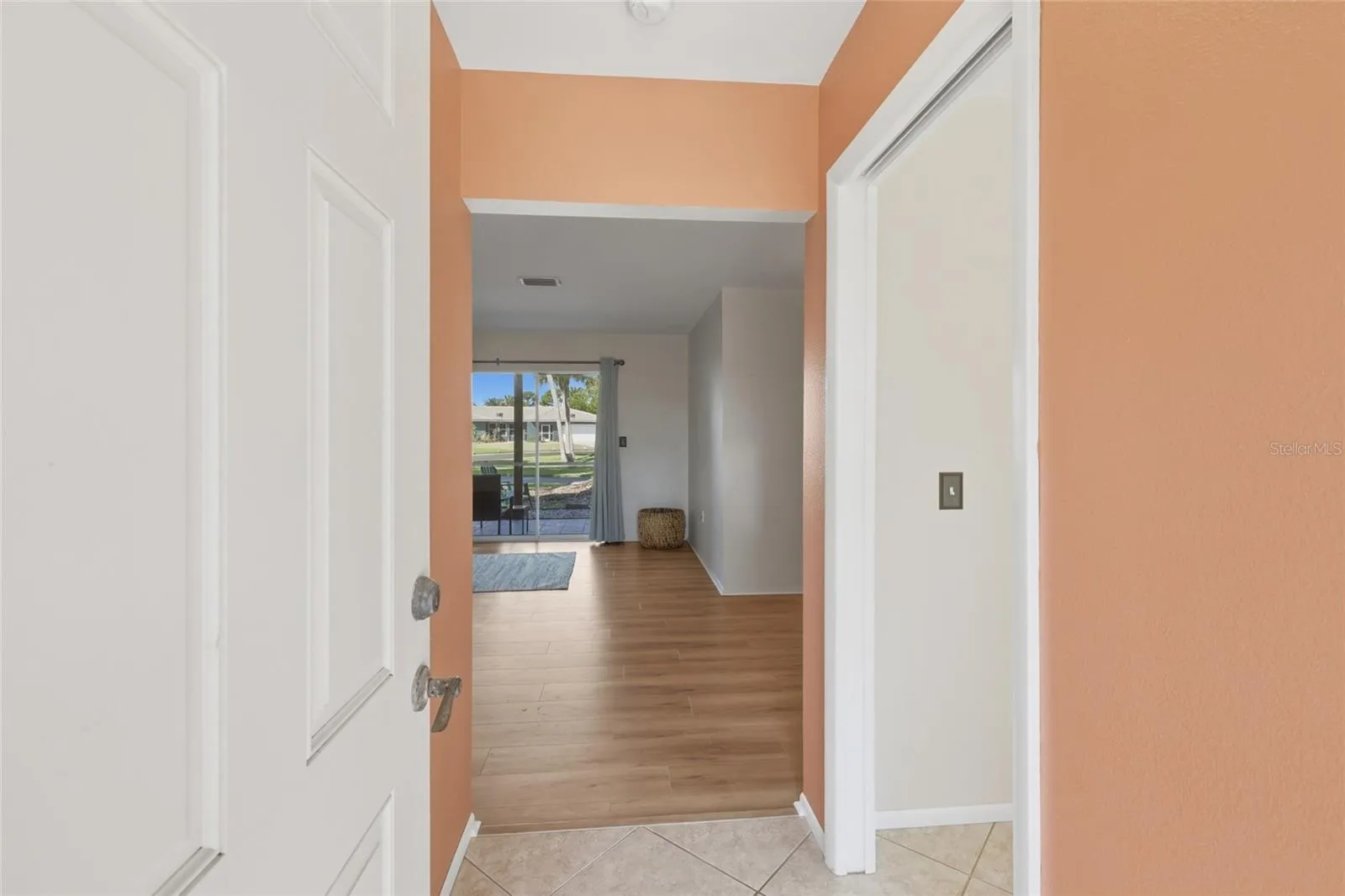 The entryway provides a view into the light filled home. The flexible room to the right has a pocket door that can be closed for privacy.