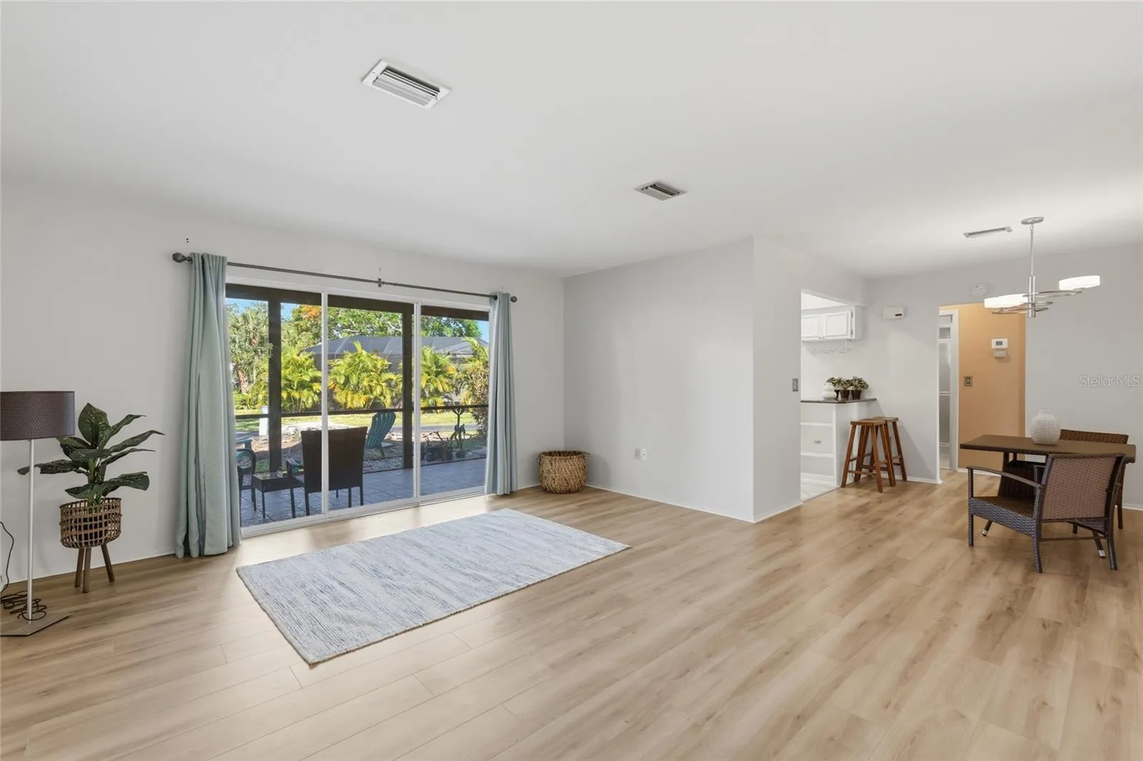 Open concept, yet thoughtfully provides some separation from the kitchen.