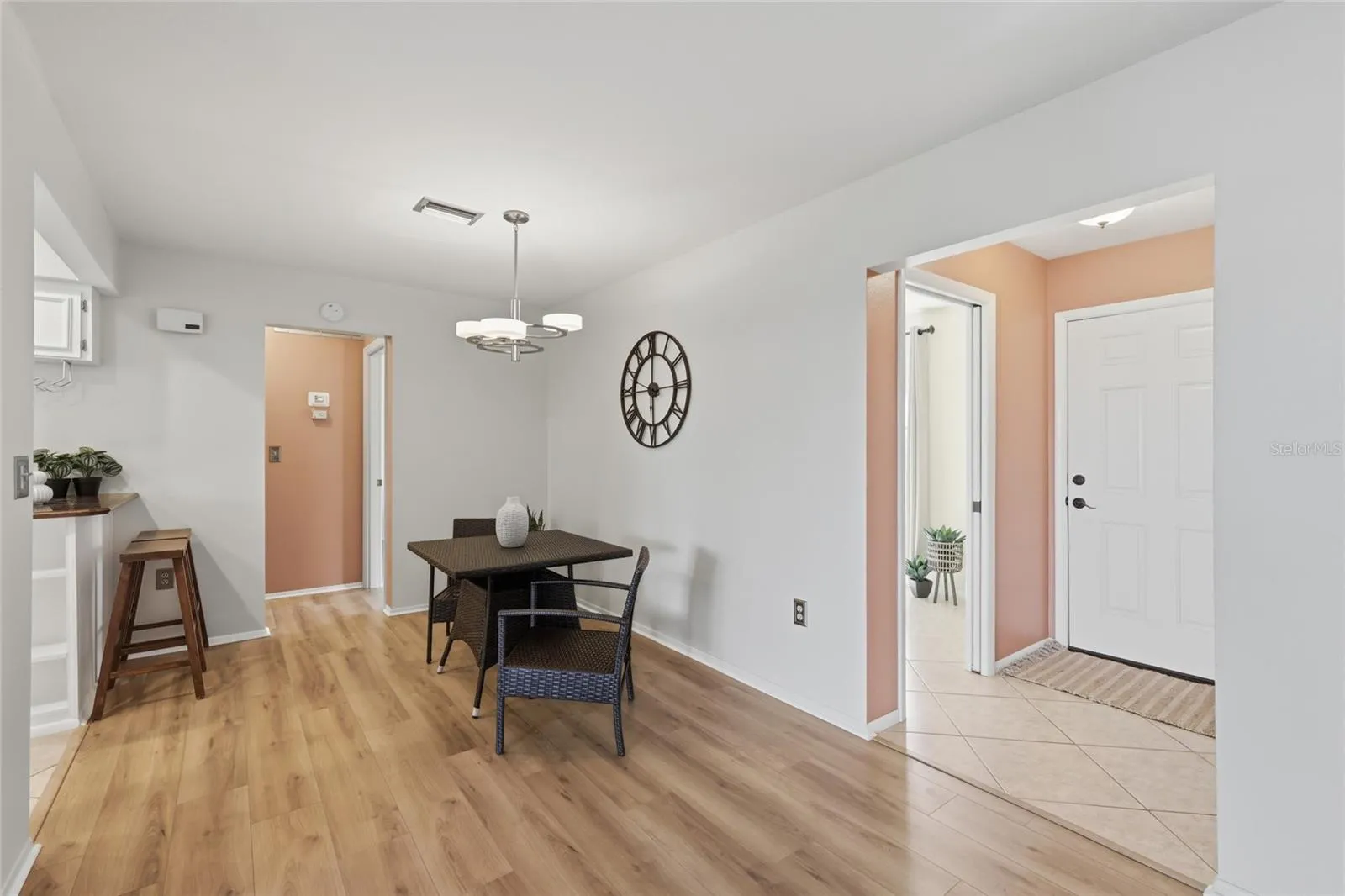 The dining room has ample space for a larger table. The kitchen is to the left, entry to the right, facing the guest room and bathroom.