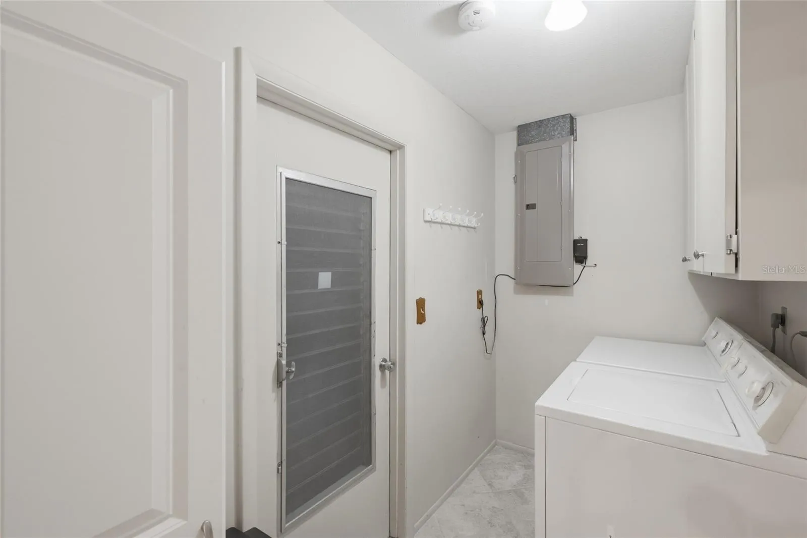 The laundry room off the kitchen features cabinets for extra storage and a door to the garage, allowing it to function as a mud room entry.