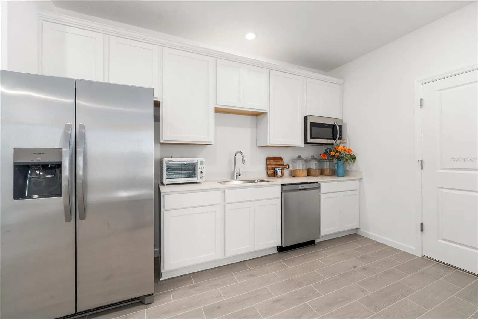 Kitchenette with Stainless Refrigerator Built in Microwave, Dishwasher Deep Soaker Sink