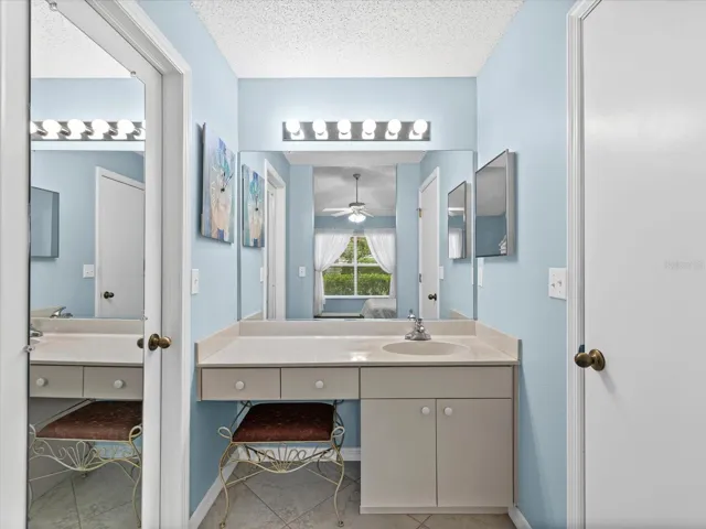 Vanity area of Primary Bathroom. Large walkin closet on left