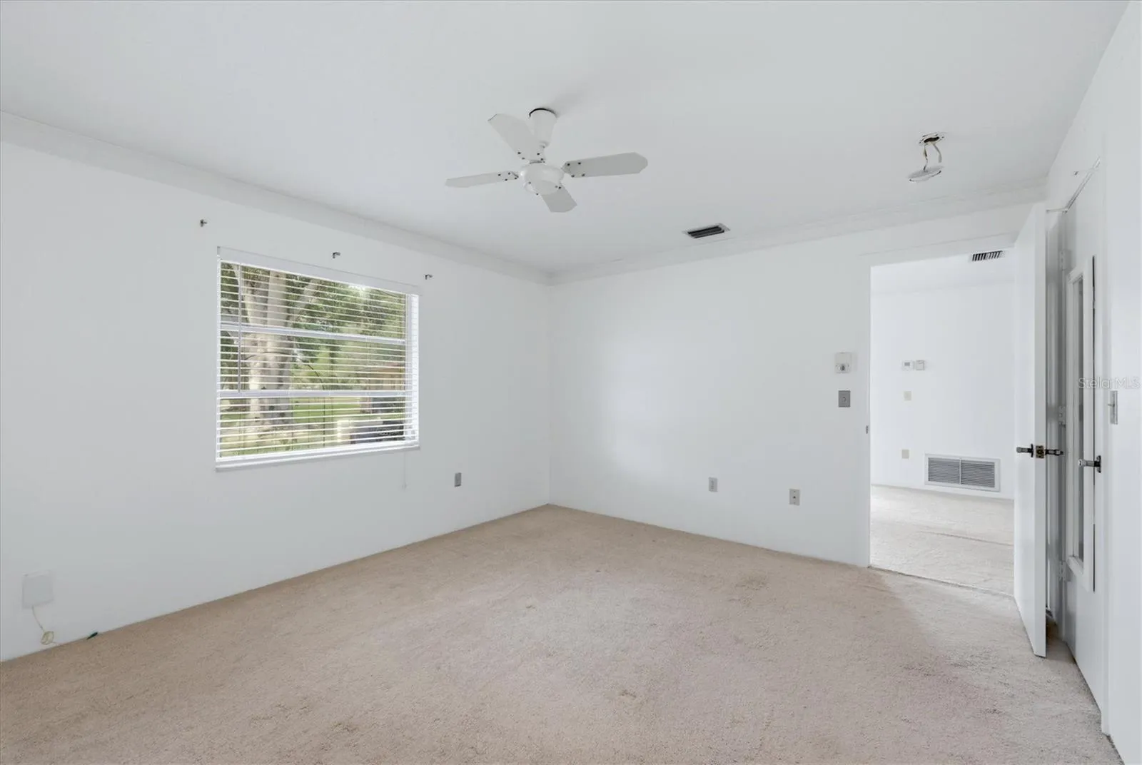 Primary bedroom faces peaceful backyard