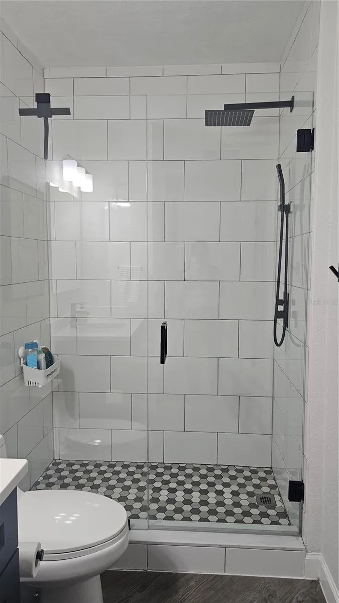 Porcelain shower with shower door guest bathroom
