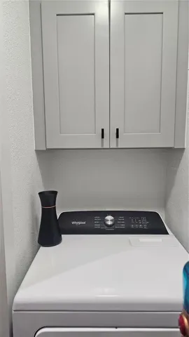 Dryer with storage cabinet located in Kitchen Closet