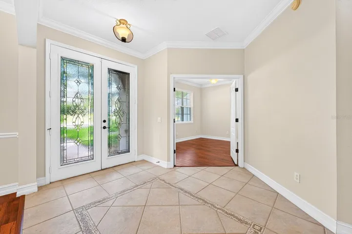 Natural light pours into the foyer throught glass inset double entry doors.