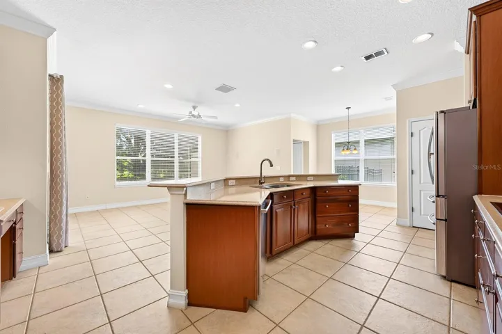 Kitchen is open to a light, bright family room and casual dining space perfect for entertaining.