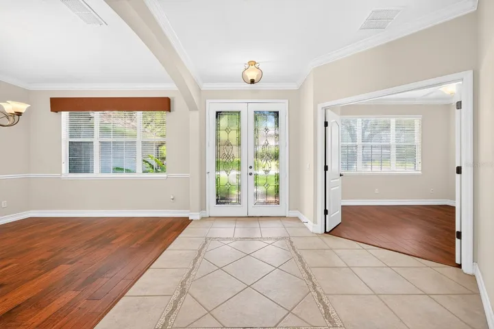 The foyer is flanked by a formal dining room and dedicated office space.