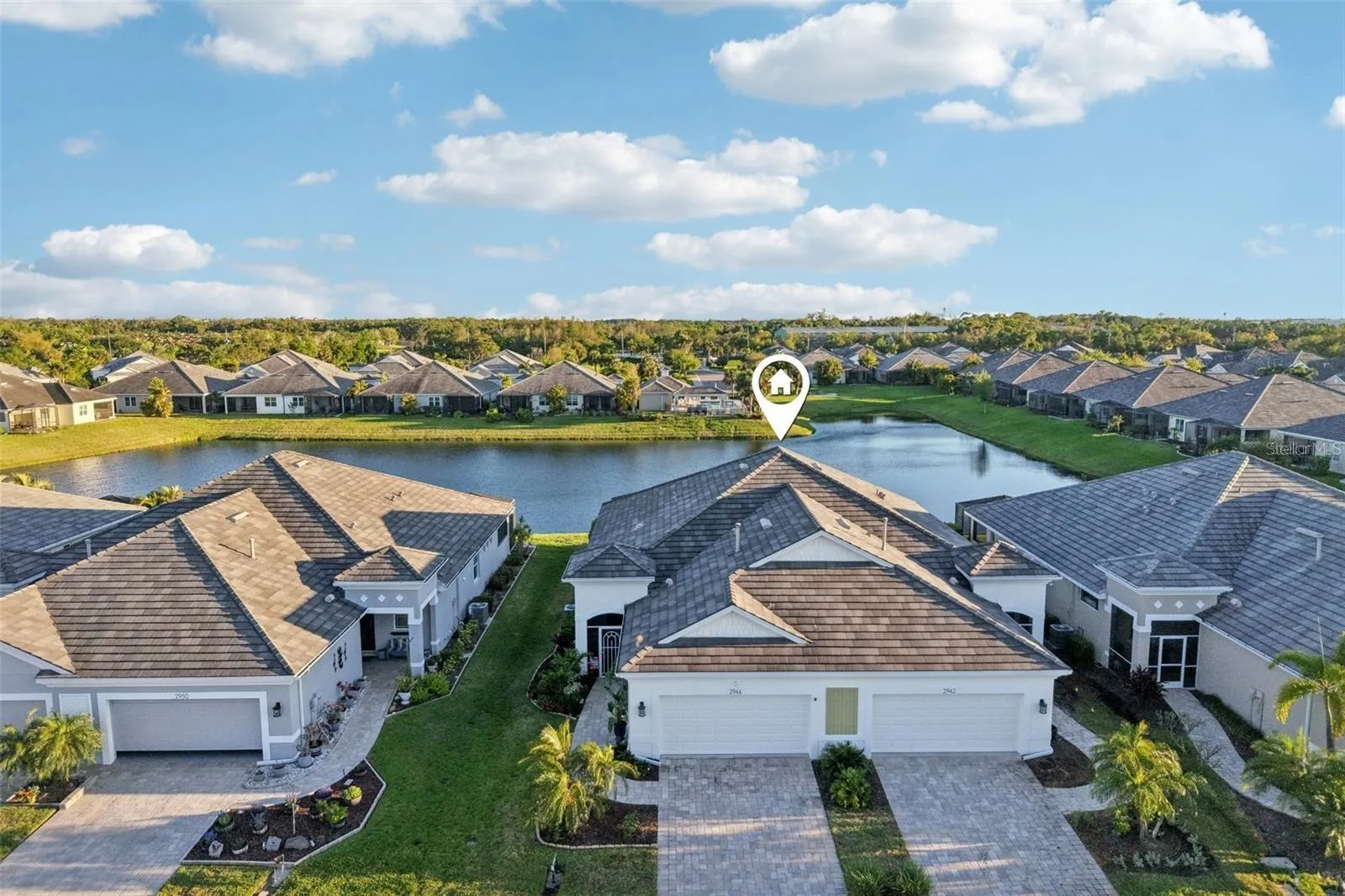 Aerial front view of home on waterfront.