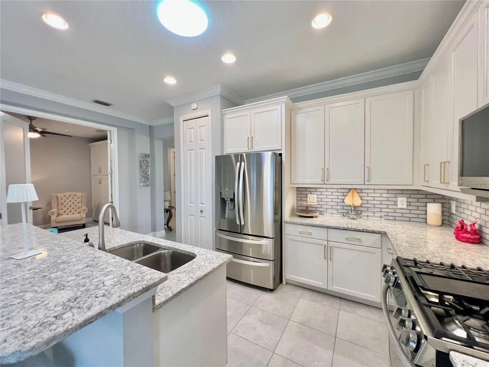 Kitchen with modern appliances and eat in island.