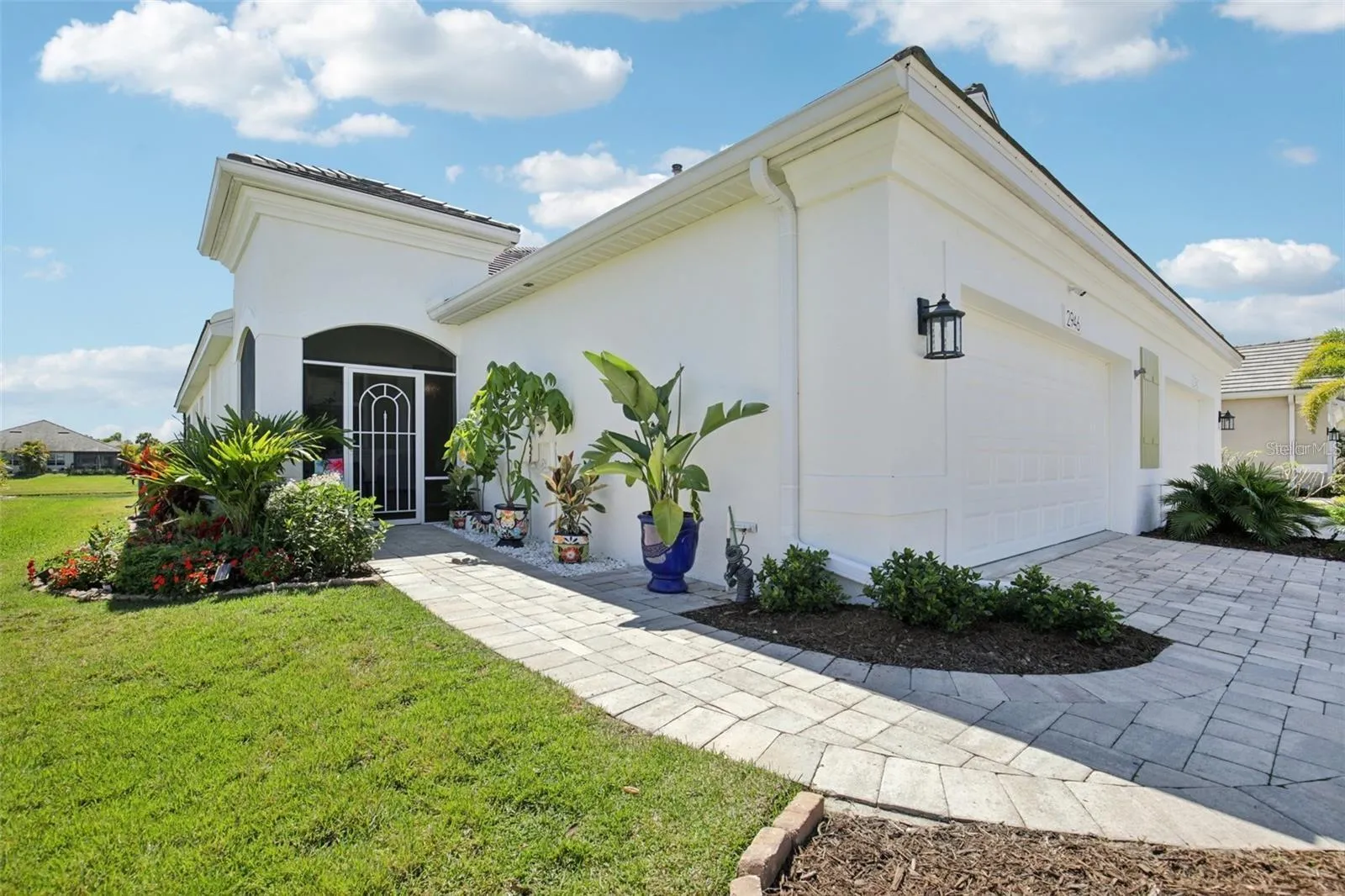 Front of home with paver driveway and walkway.