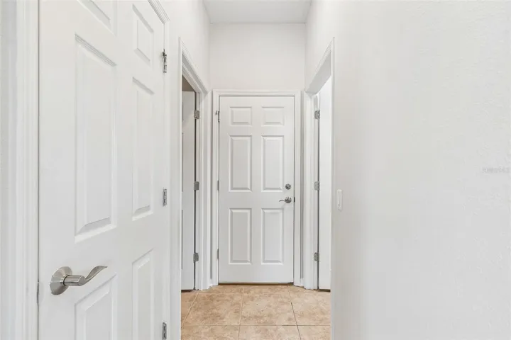 hallway leading to half bath/laundry room/garage