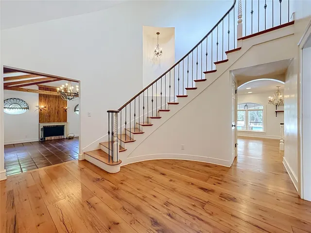 Living Room with fireplace - Sweeping Staircase - Hall to Kitchen and Family Room