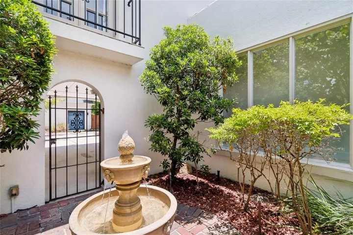 Charming courtyard with running fountain and brick patio