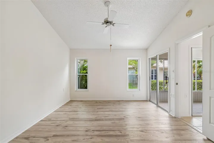 Primary Bedroom w/ 2 walk-in closets, en-suite, sliders to sun room, vaulted