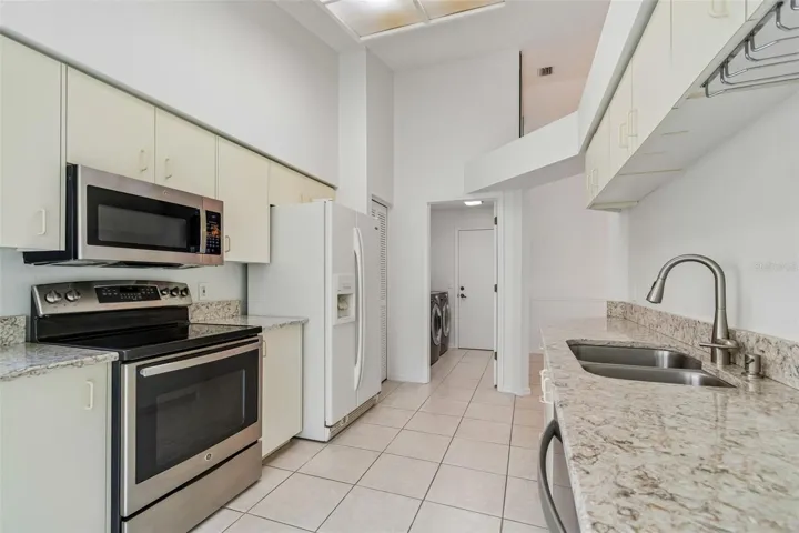 Kitchen with granite top, pantry, looking towards laundry room & garage access