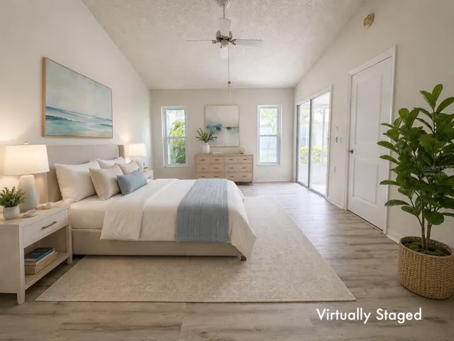 Virtually staged Main Bedroom w/ vaulted ceiling, sliders to Sun Room, En-Suite Bath