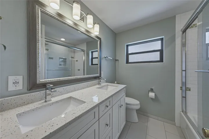 2nd Bathroom with dual sinks and tub with shower
