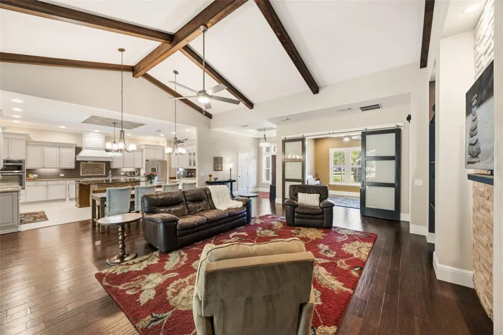 living room with vaulted ceilings and beams