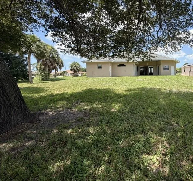 From Property line with Mature Oak Tree to Back of House