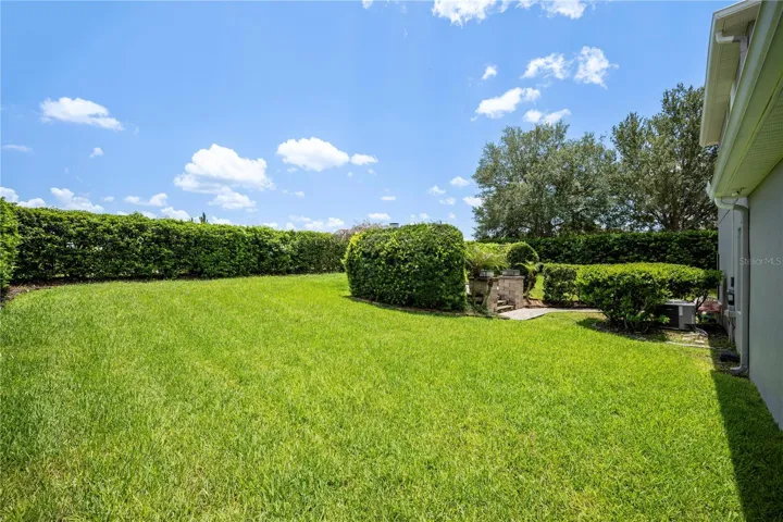 Mature hedges provide privacy to the fully fenced backyard.
