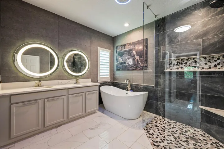 Beautiful Primary Bath with frameless shower, soaking tub and dual vanity.